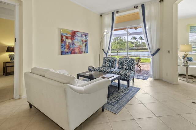 living area featuring a healthy amount of sunlight, light tile patterned flooring, and baseboards