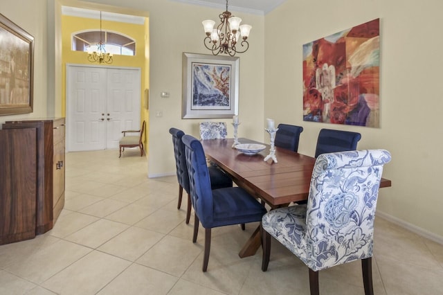 dining area featuring a chandelier, light tile patterned floors, ornamental molding, and baseboards