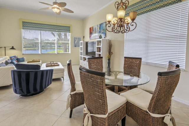 dining room featuring ceiling fan with notable chandelier, ornamental molding, and light tile patterned flooring