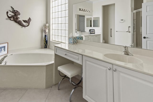 bathroom with a garden tub, vanity, a shower stall, and tile patterned floors