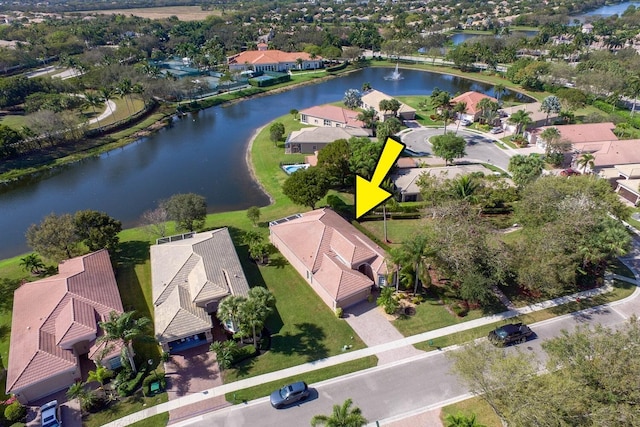 drone / aerial view featuring a water view and a residential view