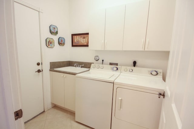 laundry room featuring a sink, cabinet space, light tile patterned floors, and washer and dryer