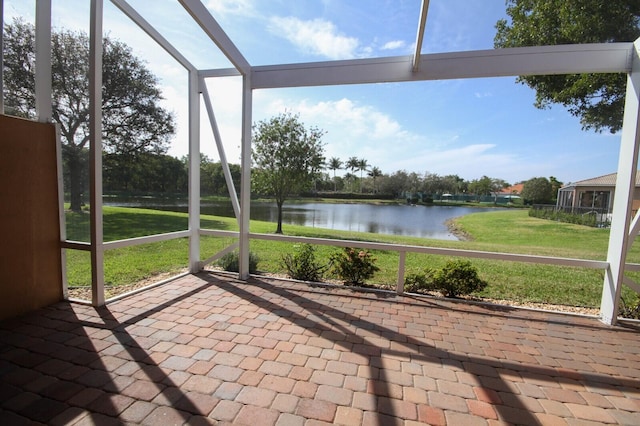 unfurnished sunroom featuring a water view