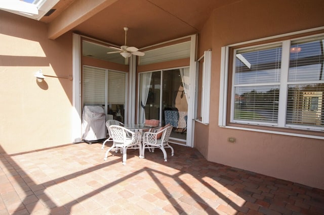 view of patio featuring outdoor dining area and ceiling fan