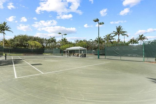 view of tennis court featuring fence