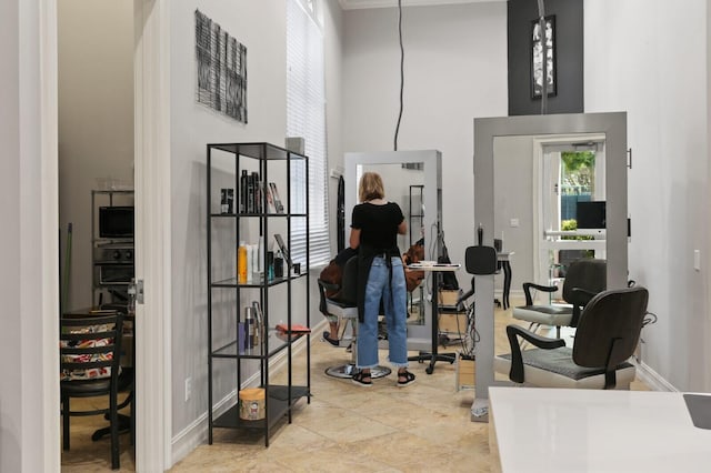 interior space with a high ceiling and baseboards