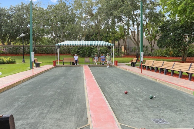 view of home's community with a yard and fence