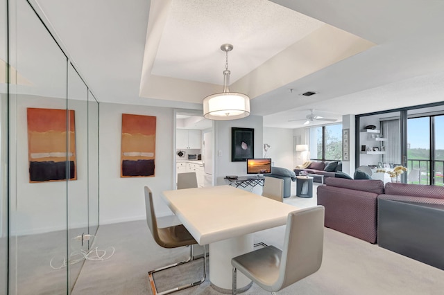 dining space featuring ceiling fan, visible vents, and light colored carpet