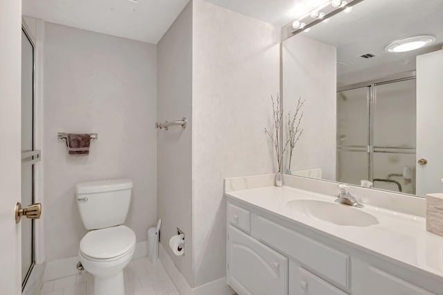 bathroom with visible vents, toilet, a shower with shower door, vanity, and baseboards