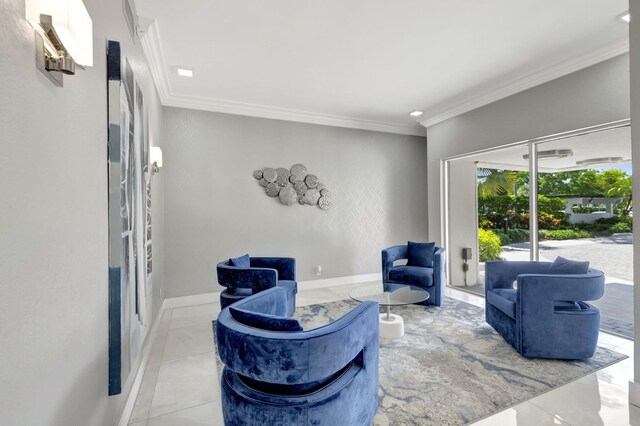 sitting room featuring ornamental molding and baseboards