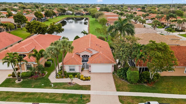 birds eye view of property with a residential view and a water view