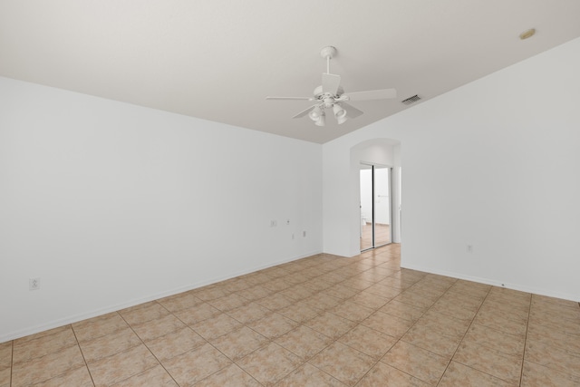 9081 Livorno St, Boynton Beach, FL 33472 - spare room featuring arched walkways, a ceiling fan, vaulted ceiling, and light tile patterned floors