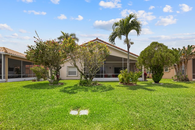 9081 Livorno St, Boynton Beach, FL 33472 - rear view of property featuring a sunroom, a lawn, and stucco siding
