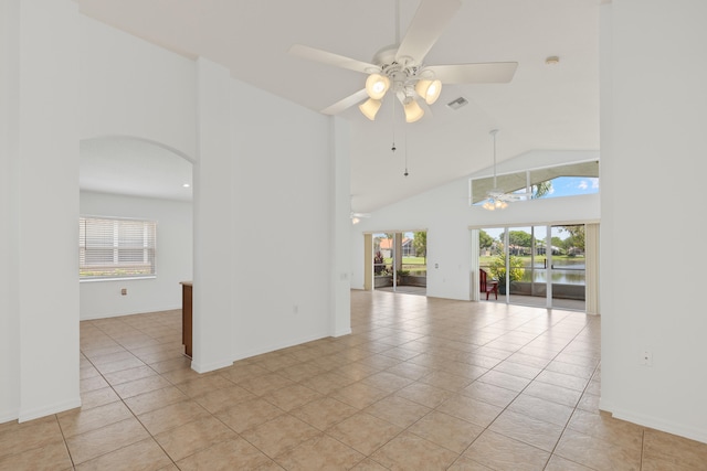 9081 Livorno St, Boynton Beach, FL 33472 - unfurnished room with a ceiling fan, plenty of natural light, light tile patterned flooring, arched walkways, and high vaulted ceiling