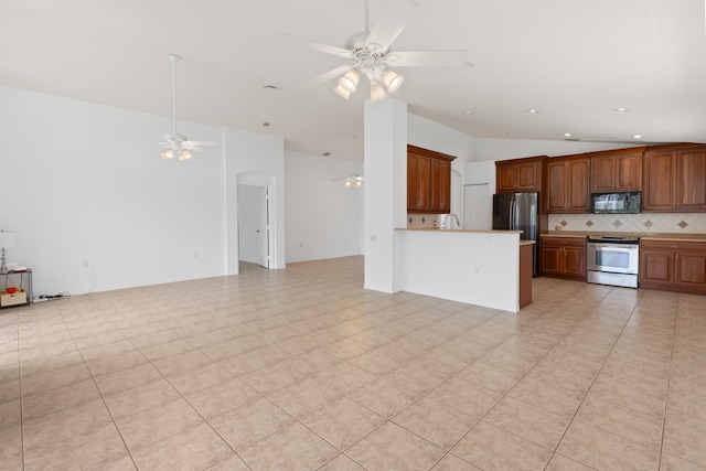 9081 Livorno St, Boynton Beach, FL 33472 - kitchen with stainless steel appliances, ceiling fan, open floor plan, vaulted ceiling, and decorative backsplash