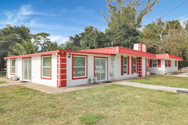 ranch-style house with a front yard and metal roof