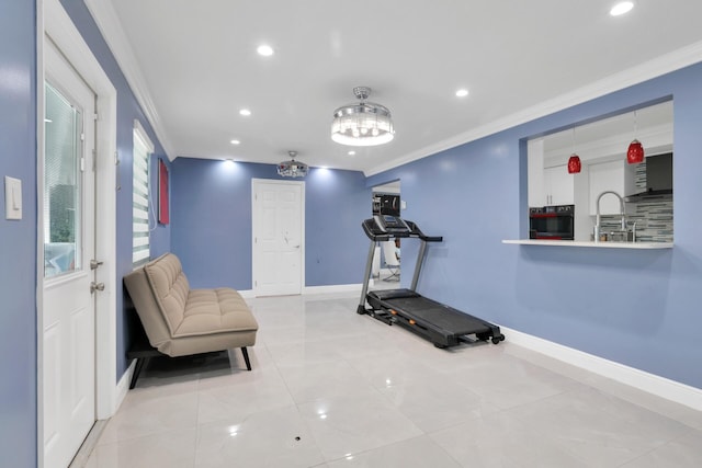 workout area featuring baseboards and ornamental molding