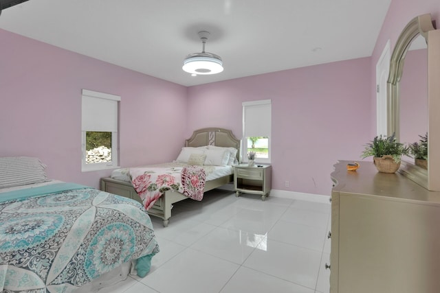 bedroom featuring baseboards and light tile patterned floors