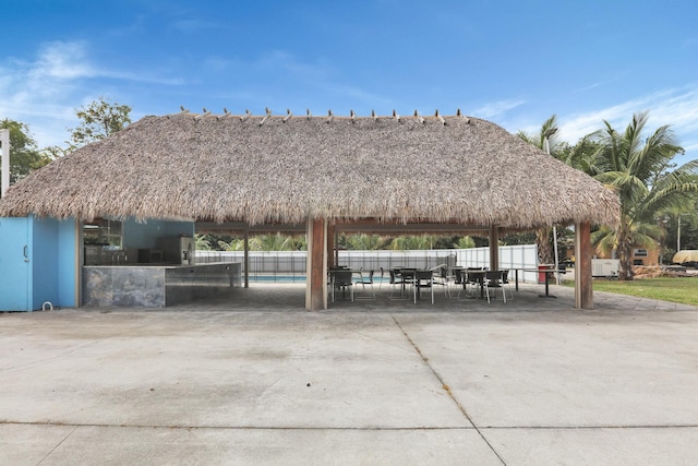 view of home's community with a gazebo, a patio area, and fence