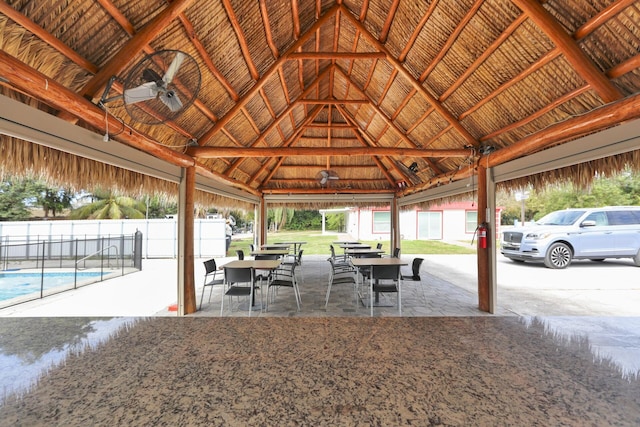 view of patio / terrace with ceiling fan, a gazebo, outdoor dining space, and fence