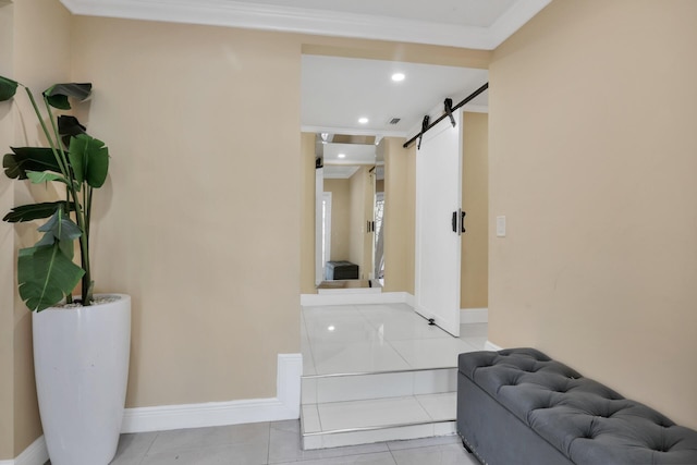 hall featuring a barn door, light tile patterned flooring, recessed lighting, baseboards, and crown molding