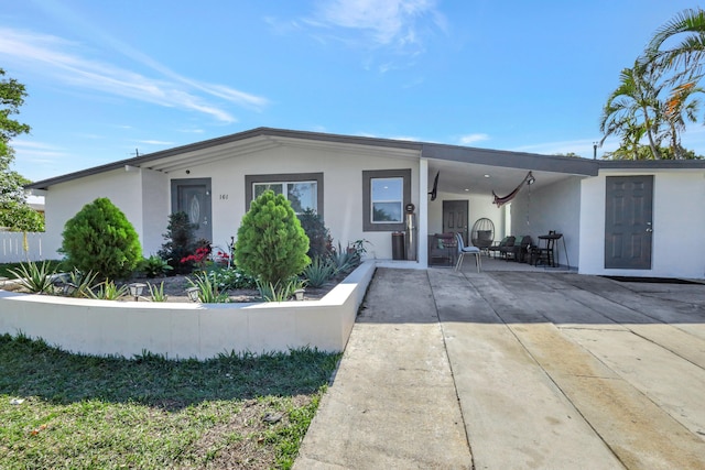 view of front of house featuring a patio and stucco siding