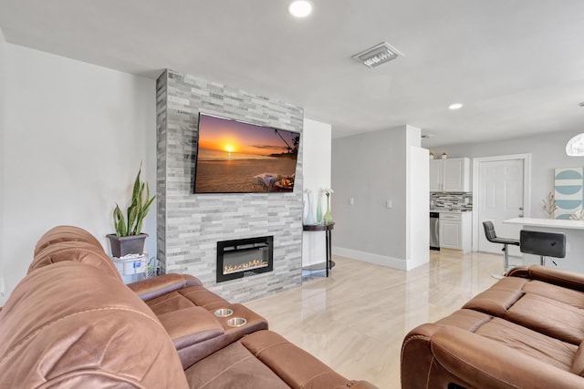 living area featuring recessed lighting, a fireplace, visible vents, and baseboards