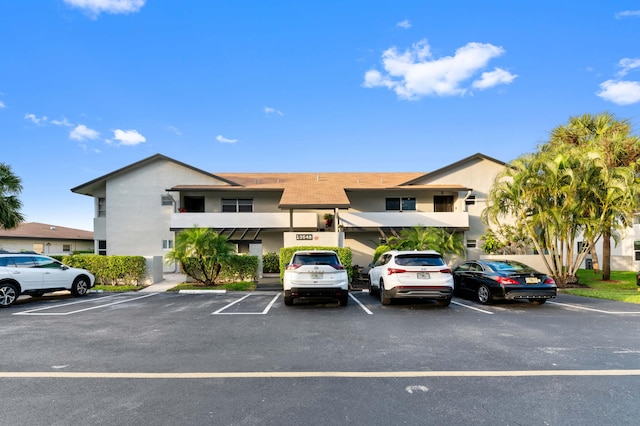 view of building exterior featuring uncovered parking