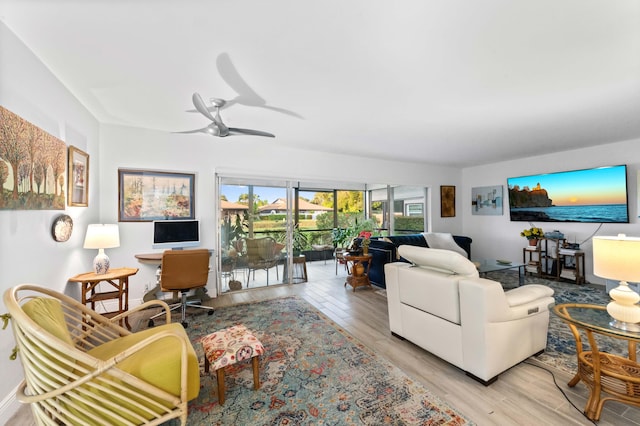 living room featuring a ceiling fan and light wood-style floors