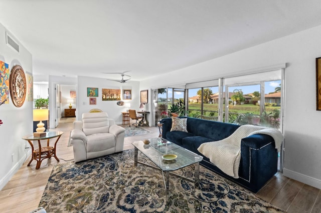 living room with a healthy amount of sunlight, visible vents, and light wood finished floors