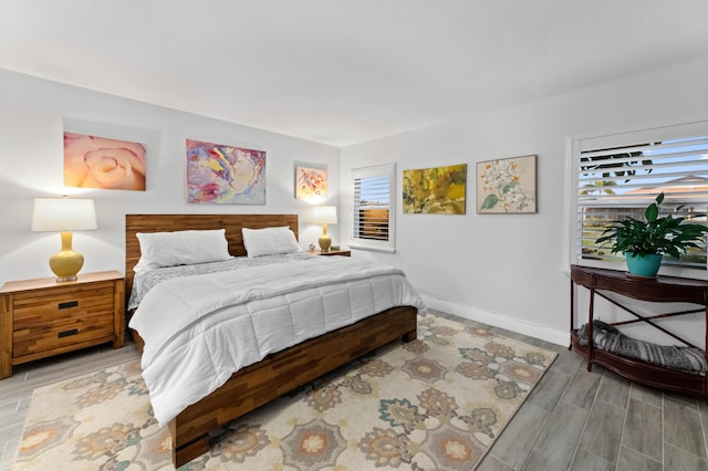 bedroom with light wood-type flooring and baseboards