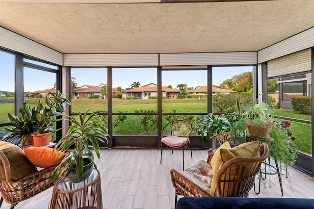 sunroom featuring a residential view