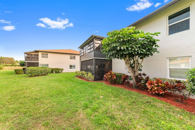 view of yard with a sunroom