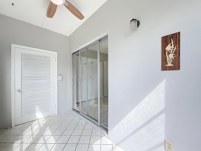 bathroom with ceiling fan and tile patterned floors