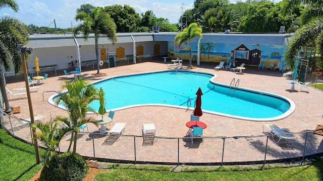 pool with fence and a patio