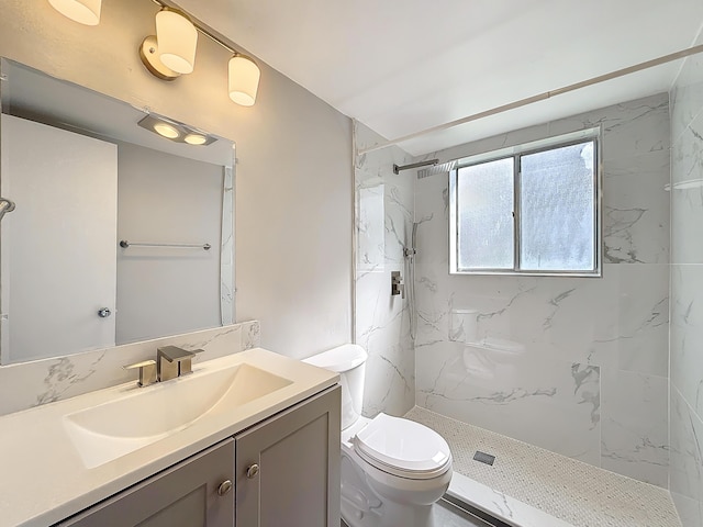 full bathroom with toilet, a marble finish shower, and vanity