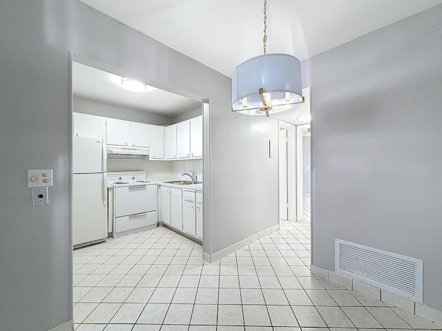 kitchen featuring white appliances, visible vents, white cabinets, hanging light fixtures, and light countertops