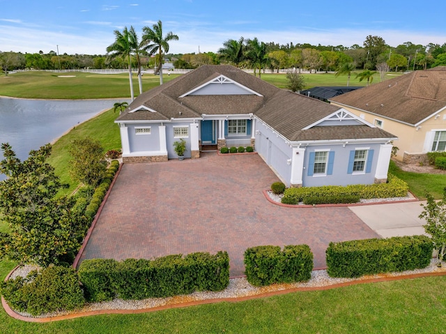 ranch-style home with stucco siding, decorative driveway, and roof with shingles