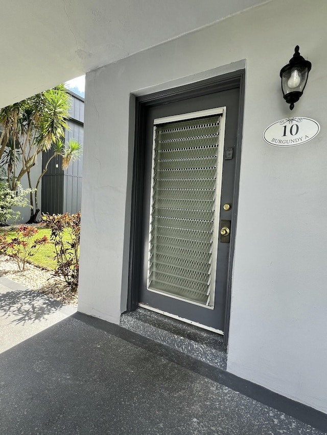 property entrance with stucco siding