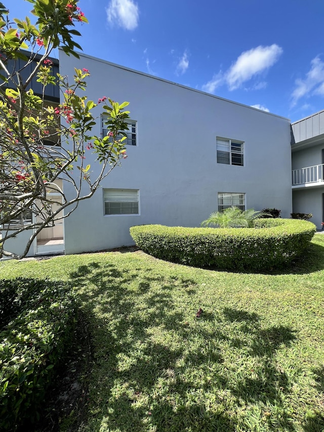 view of home's exterior featuring a yard and stucco siding