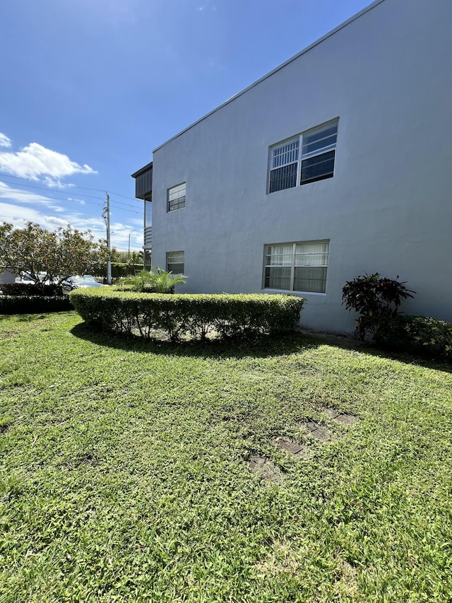 view of home's exterior featuring a yard and stucco siding