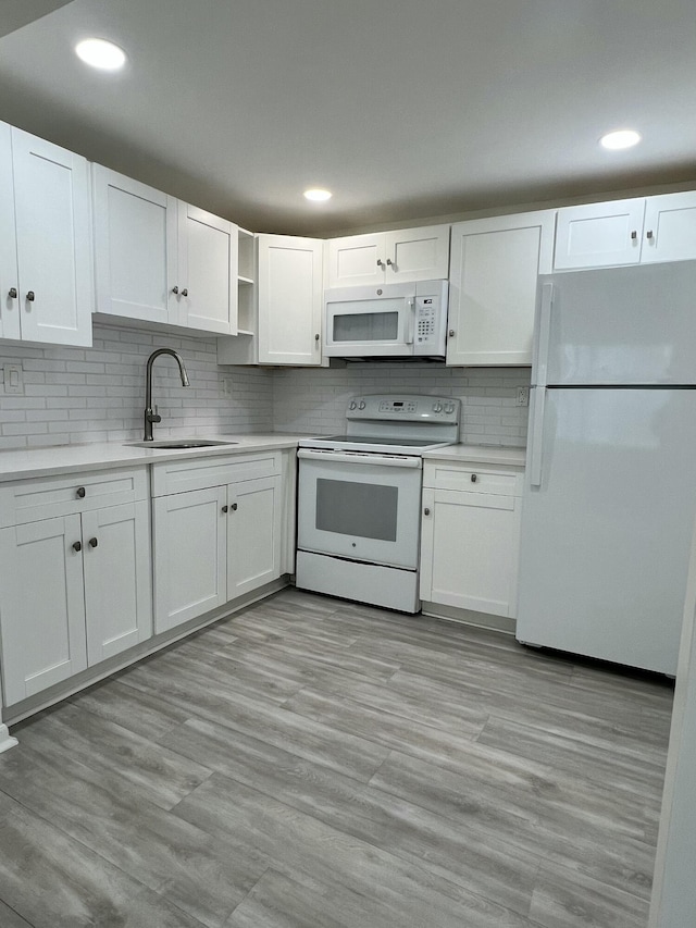 kitchen with white appliances, white cabinetry, and open shelves