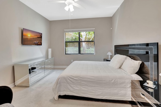 bedroom featuring baseboards, a ceiling fan, and light colored carpet