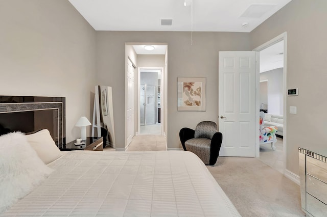 bedroom featuring light carpet, baseboards, and visible vents