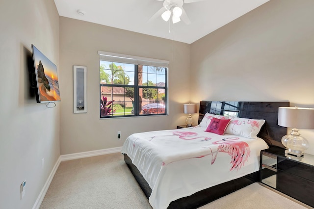 bedroom featuring baseboards, ceiling fan, and light colored carpet