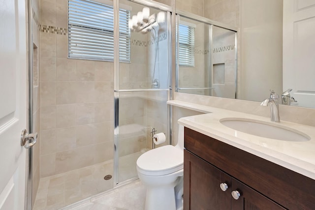 full bathroom featuring toilet, a shower stall, a wealth of natural light, and vanity