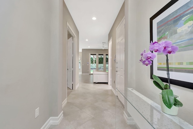 corridor featuring recessed lighting and baseboards