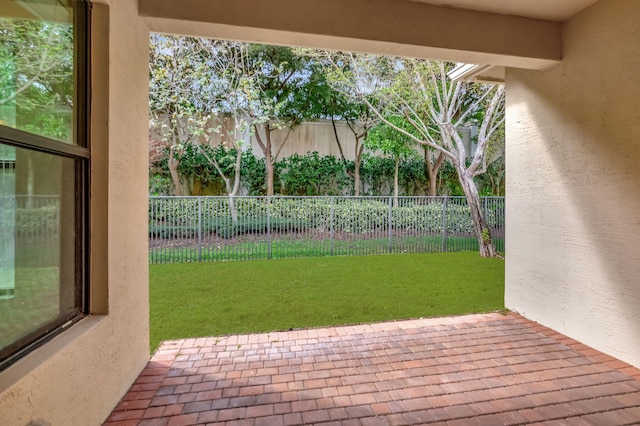 doorway to outside with a textured wall and brick floor