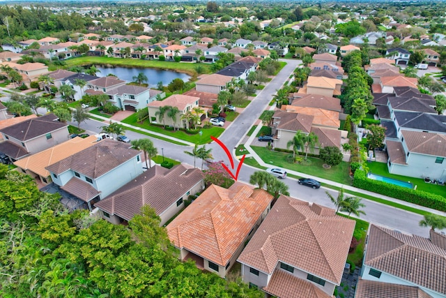 aerial view with a water view and a residential view