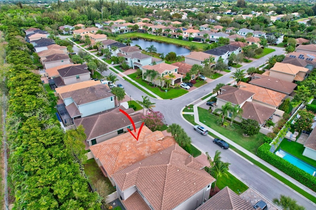 birds eye view of property with a residential view and a water view